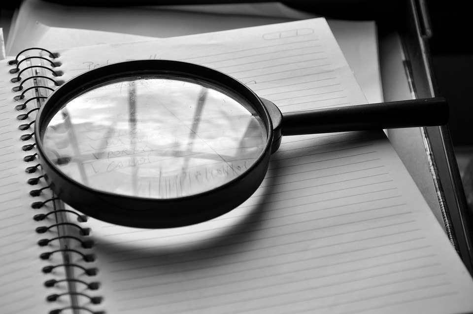 a magnifying glass on a journal.