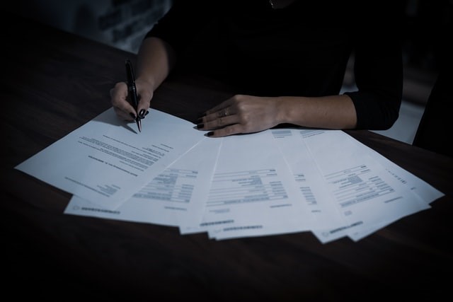 An internal auditor analysing a firm's environmental paperwork